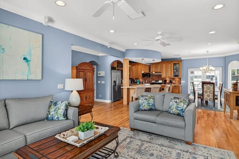 Elegant Captiva retreat featuring a spacious, light-filled living room with a fireplace, plantation shutters, and upscale coastal design.