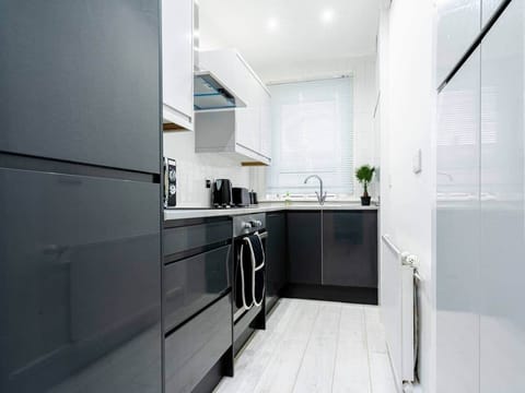 The kitchen has a contemporary and stylish aesthetic that seamlessly integrates with the overall ambiance of the house. Clean lines, minimalist decor, and high-quality materials create an inviting space that is both visually striking and practical.