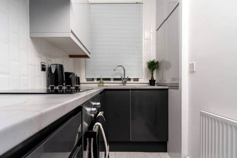 The kitchen has a contemporary and stylish aesthetic that seamlessly integrates with the overall ambiance of the house. Clean lines, minimalist decor, and high-quality materials create an inviting space that is both visually striking and practical.