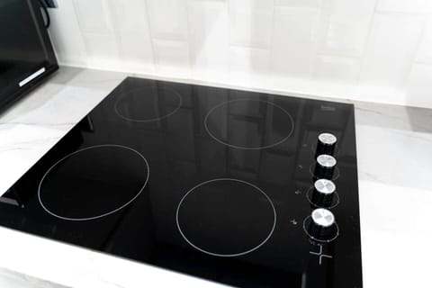 The kitchen has a contemporary and stylish aesthetic that seamlessly integrates with the overall ambiance of the house. Clean lines, minimalist decor, and high-quality materials create an inviting space that is both visually striking and practical.