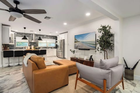 Enjoy this inviting open living space with cozy seating, modern accents, and a seamless connection to the kitchen and dining area. Perfect for relaxing, entertaining, and making memories in a bright, stylish setting.