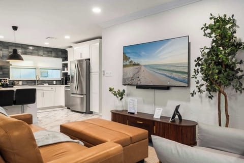 Unwind in this stylish living room with plush leather seating, a large smart TV, and modern décor. Open to the kitchen for easy entertaining, it’s the perfect spot to relax after a day of exploring.