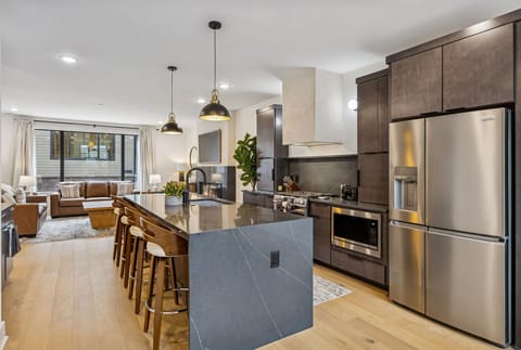 Kitchen: Sleek lines, warm tones, and high-end touches — the perfect kitchen for cooking, entertaining, and enjoying life together.