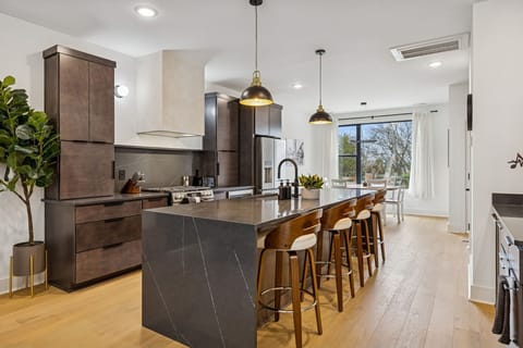 Kitchen: Sleek lines, warm tones, and high-end touches — the perfect kitchen for cooking, entertaining, and enjoying life together.