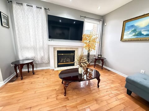 Unwind in this bright, cozy living space where comfort meets style. Gather around the warm fireplace, stream your favorite shows on the large TV, and enjoy the natural light pouring in through the windows. With elegant hardwood floors, tasteful décor, and
