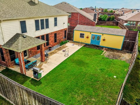 Spacious fenced backyard with patio, grill, and charming detached studio