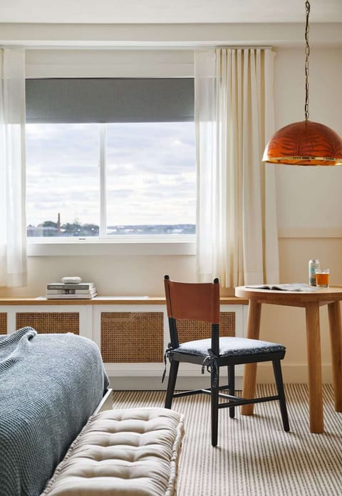 Bright room with window seating and small desk table