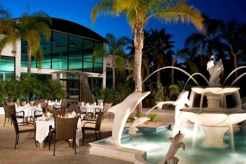 Outdoor dining area with dolphin water fountain