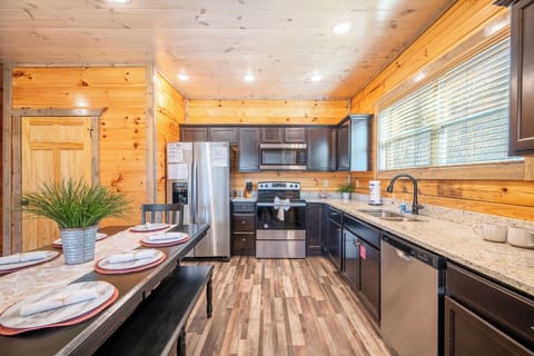 Your fully equipped kitchen features granite counters, stainless appliances, and cozy wood beams for memorable meals together.