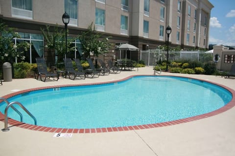 Dive into sparkling sunshine and unwind on loungers.