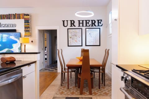 Gather around your stylish dining table with warm wood chairs and modern pendant lighting, where home-cooked meals become memories.