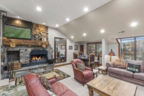 Cozy up by your crackling stone fireplace while watching the game on the large TV, on plush leather seating.