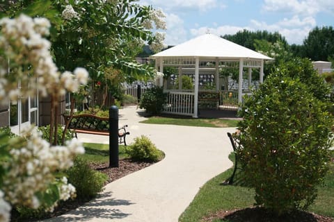 Stroll through blooming gardens to a shaded gazebo retreat.