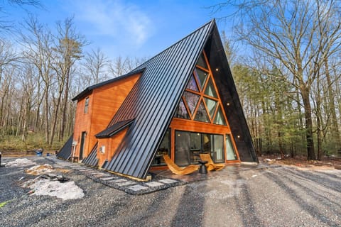 Arrive to this stunning A-frame cabin with its iconic glass facade and covered porch