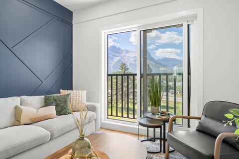 Cozy living room with a queen sofa bed and calming mountain views.