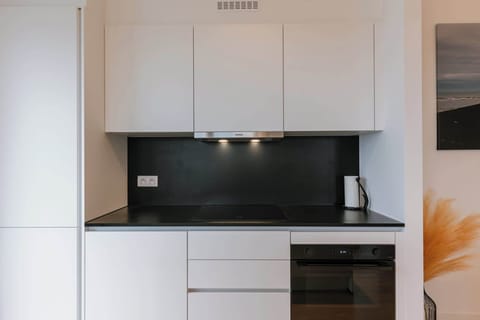 The fully equipped kitchen offers everything you need for a gourmet stay, including a state-of-the-art oven and induction cooktop.