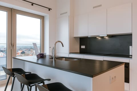 The fully equipped kitchen offers everything you need for a gourmet stay, including a state-of-the-art oven and induction cooktop.