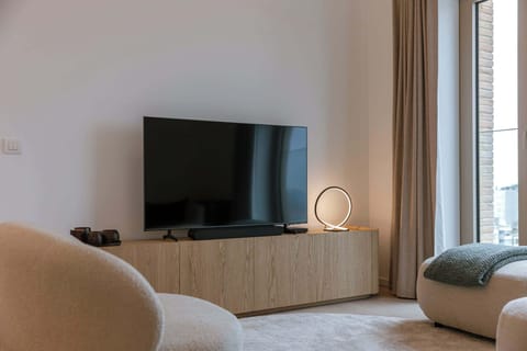 Inviting living space featuring organic modern design, a plush sofa, and stunning floor-to-ceiling views.