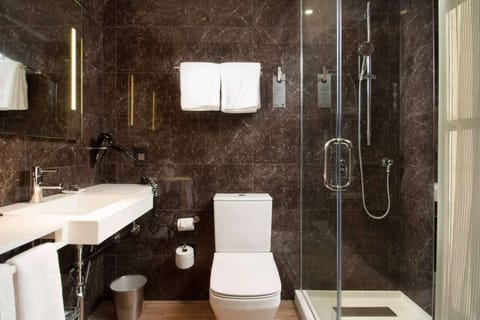 Bathroom with glass shower, clean towels, and vanity sink