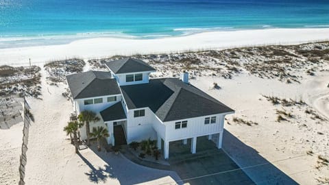 Stunning beachfront property positioned directly on pristine white sand with crystal-clear Gulf waters stretching endlessly before this coastal retreat.
