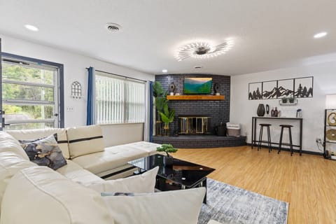 Gather around the sleek fireplace with its bold brickwork and warm wood mantle, or kick back on the leather sectional while streaming your favorite shows on the big screen.