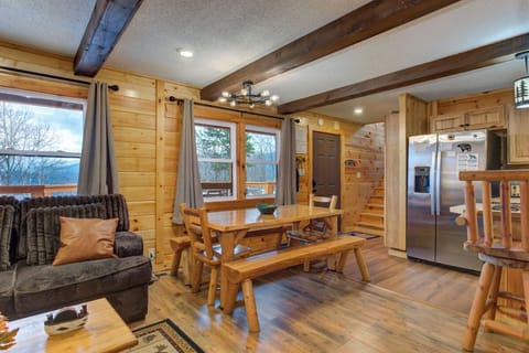 Rustic wooden beams frame your mountain retreat dining space, where handcrafted log furniture invites cozy meals with scenic views.