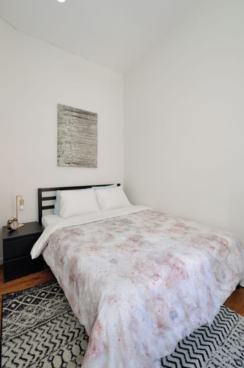 Drift off to sleep in your cozy bedroom, where crisp white linens and soft textures create the perfect retreat.