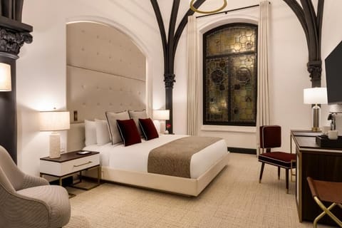 Unwind beneath soaring arches in a serene, designer bedroom.