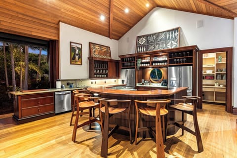 Your gourmet kitchen features rich wood cabinetry, modern appliances, and a curved island perfect for memorable meals.