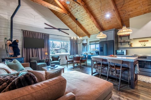 Open living, dining, and kitchen space with vaulted ceilings. A great place to relax together, cook meals, and enjoy time inside after a day outdoors.