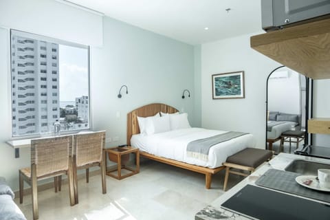 Bedroom with seating area and city view.