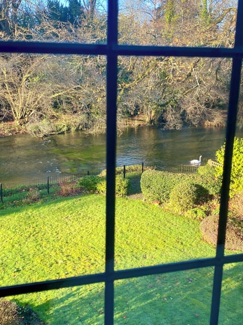 Wake to tranquil garden and river views at Dove Cottage