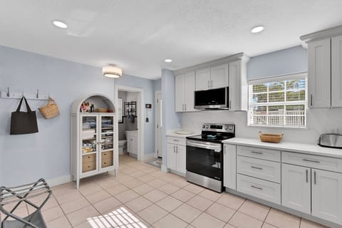 Fully equipped kitchen with fridge, oven, stove, microwave, toaster, coffee maker, basic cooking utensils, dishware, and more!