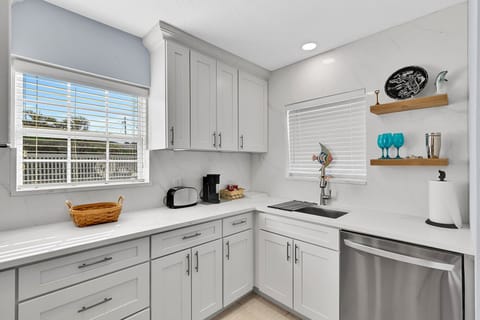 Fully equipped kitchen with fridge, oven, stove, microwave, toaster, coffee maker, basic cooking utensils, dishware, and more!