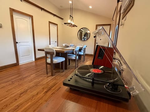 Record player and bluetooth speakers right next to dining table