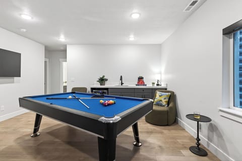 Dedicated game room with a pool table and lounge seating—perfect for friendly competition and relaxed nights in.