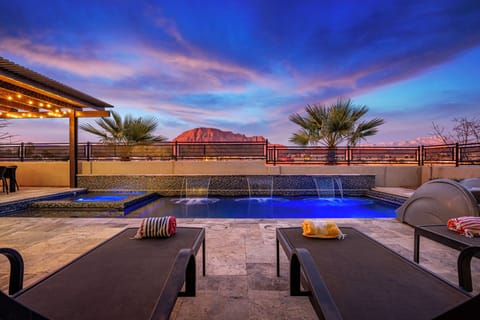 Sparkling pool and spa with expansive red rock views.