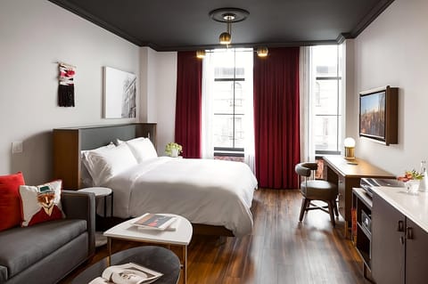 Stretch out in style with lounge seating and warm wood floors.