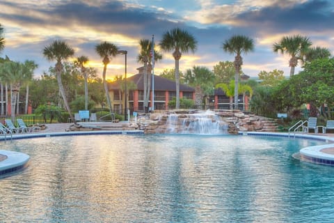 Unwind at sunset beside the sparkling pool and waterfall.