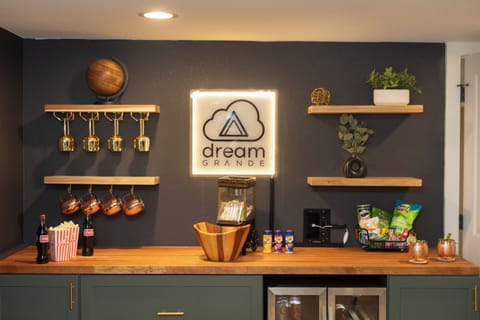 Bar area with drink glasses and popcorn machine for entertaining