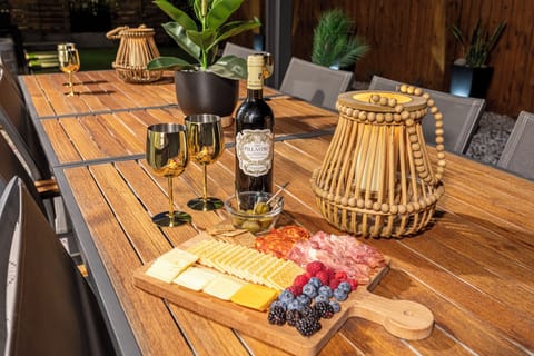 Large outdoor dining table under pergola, perfect for gatherings