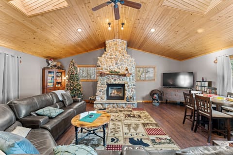 Open-concept living & dining with vaulted ceilings, natural light, outdoor views