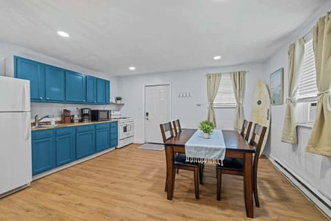 Bold blue cabinets and modern appliances make cooking a joy in this well-equipped kitchen. The space feels fresh, open, and full of natural light. 