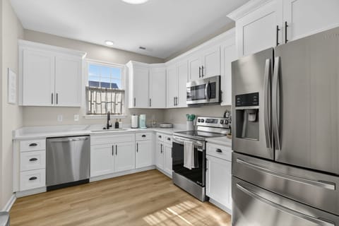 Whip up your favorites in this bright, modern kitchen with stainless appliances and crisp white cabinetry. It's the perfect blend of style and function for any length of stay. 