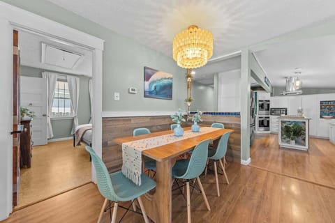 A beautifully set dining area with elegant lighting and decor. It’s an inviting place for shared meals and conversations.