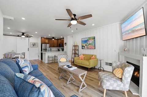 The fully functional gas fireplace offers comforting warmth on cooler days and enhances the room's inviting ambiance.