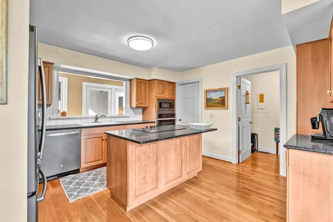 Step into your spacious kitchen with warm wood cabinetry, granite countertops, and a center island perfect for meal prep.