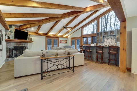 couch, living area, television, fireplace, bar island with seating