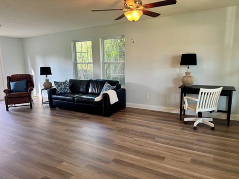 Family room area located on main floor with TV and dedicated work space.