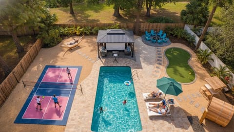 Private resort style backyard with Pickleball, heated pool, golf, shower, etc